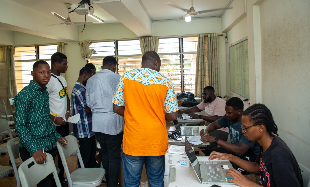 Students and programme staff working on AgriConnect laptops